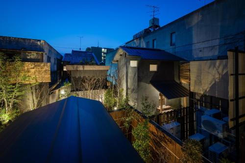 a building with a blue canopy in a city at Nazuna Kyoto Gosho in Kyoto