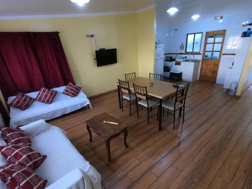 a living room with a couch and a table with chairs at Hogar Doña Gloria in Iquique