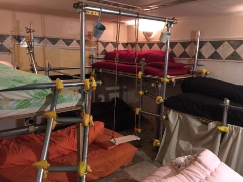 a group of bunk beds in a room at ILA Hakushu Guesthouse in Hokuto