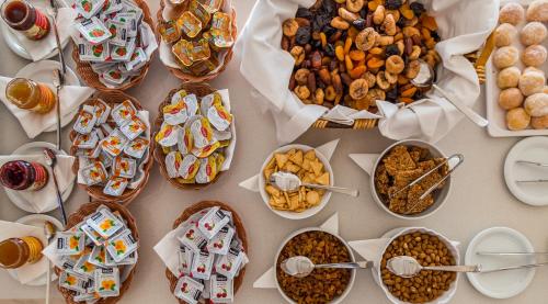 a table with a bunch of different types of food at Sun Hall Hotel in Larnaka