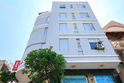 a tall white building with a window at Song Xanh Hotel near SECC - FV in Ho Chi Minh City