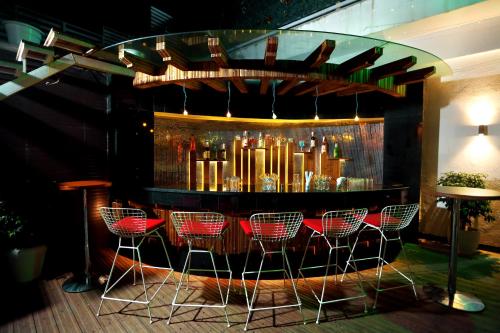 a bar with red chairs in front of it at Comfort Inn Benares in Varanasi