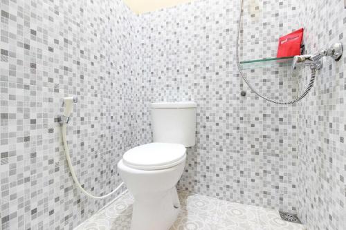 a bathroom with a toilet and a shower at RedDoorz near Balekambang City Park in Solo