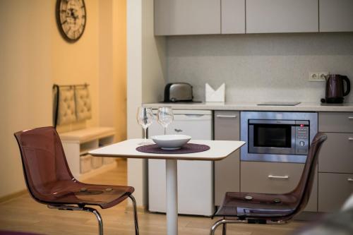 a small kitchen with a table and two chairs at Raugyklos g. apartment in Vilnius