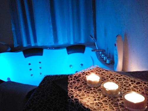 a room with a table with three candles on it at B&B Vistamareblu in San Foca