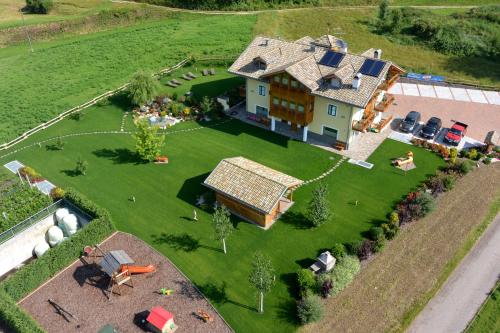 an aerial view of a large house with a yard at Agritur Maso Chemela in Cavalese