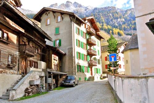 a street in a town with buildings and a car at Grosshus Vals in Vals