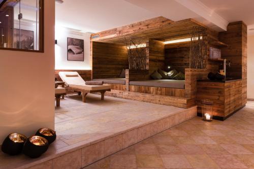 a hotel room with two beds and a desk at Hotel Brugger in Fulpmes