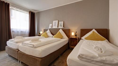 En eller flere senge i et værelse på Neckarbett - Self Service Hotel