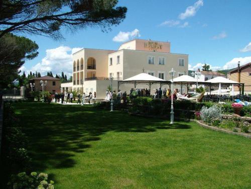 a group of people standing outside of a building at Hotel Holiday Sul Lago in Bolsena