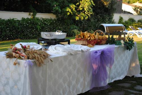 a white table with fruits and vegetables on it at Hotel Holiday Sul Lago in Bolsena
