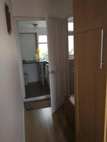 an open door to a kitchen with a sink at Rest room near to Heathrow Airport in Ashford