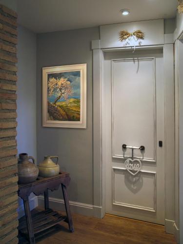 a door in a room with a painting and a table at Hotel Santa Maria de Alquezar in Alquézar
