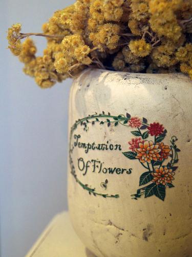 a white vase filled with flowers on a table at Hotel Santa Maria de Alquezar in Alquézar