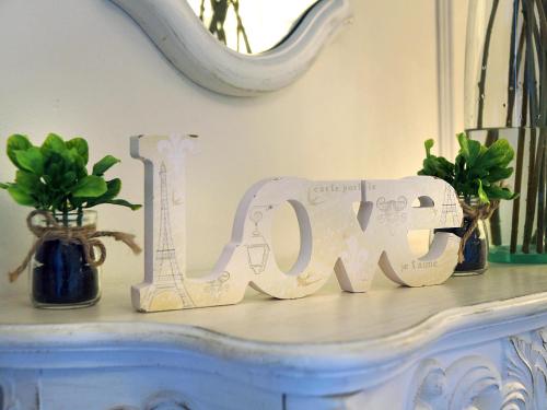 a white sign that says love sitting on a table at Hotel Santa Maria de Alquezar in Alquézar