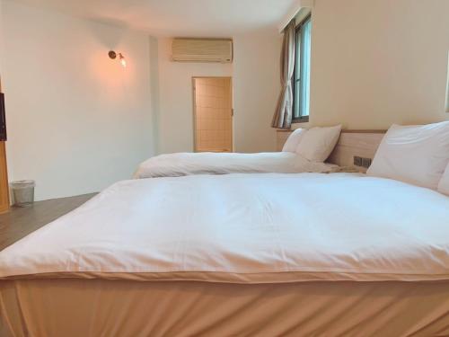 Postel nebo postele na pokoji v ubytování Raise Hotel Taichung