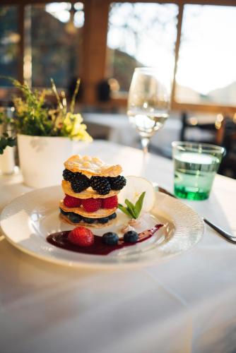 a white plate with a dessert on a table at Der Kirchheimerhof - Superior in Bad Kleinkirchheim