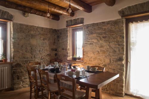 ein Esszimmer mit einem Holztisch und Stühlen in der Unterkunft Agriturismo Angiò nel Cerè in Bracelli