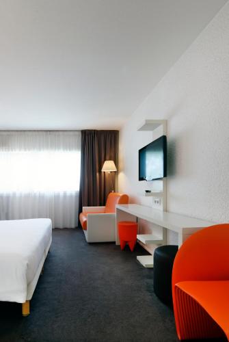 Ένα ή περισσότερα κρεβάτια σε δωμάτιο στο ibis Styles Chalon sur Saône
