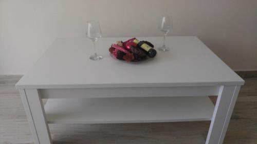 a white table with two wine glasses and a purse at Your Home Montenegro in Dobra Voda