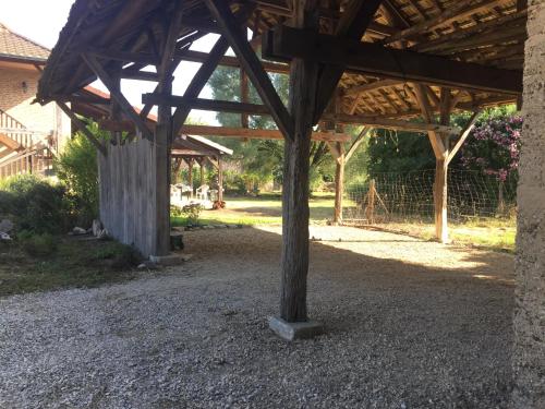 a wooden pavilion with a wooden pole in a yard at Gite Evidence in Varennes-sur-le-Doubs