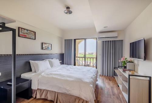 a hotel room with a bed and a television at Milan Yilan in Wujie