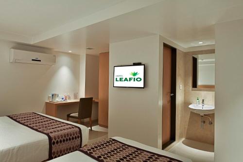 Postel nebo postele na pokoji v ubytování Hotel Leafio-Near Airport