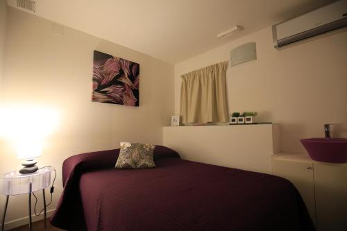 a small bedroom with a bed and a window at Hotel Centrale in Siracusa