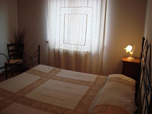 a bedroom with a bed in front of a window at Poggio San Giacomo in Baschi