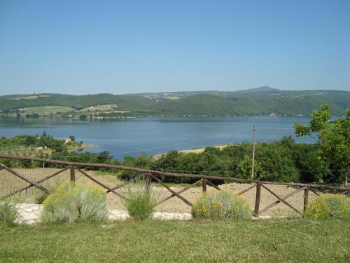a view of a lake behind a fence at Poggio San Giacomo in Baschi