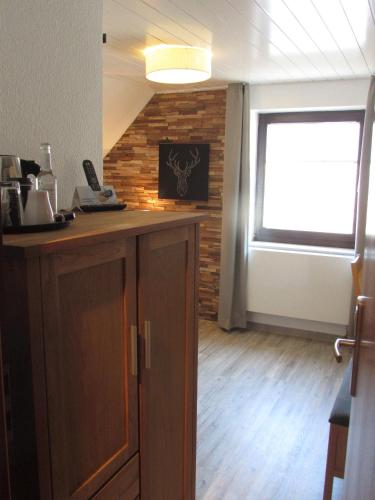 a kitchen with a counter and a window in a room at Hotel Weilerhof in Dormagen