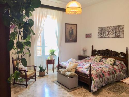 パルティニーコにあるCasa Vacanze LA CASA DI NANCYのベッドルーム1室(ベッド1台、椅子、植物付)
