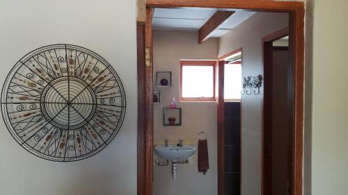 a bathroom with a sink and a mirror on the wall at Barrydale Accommodation, Backpackers in Barrydale