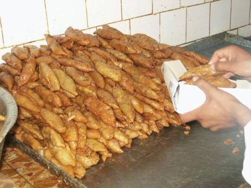 a person is holding a box of food at Auberge Alferdaous in Tataouine