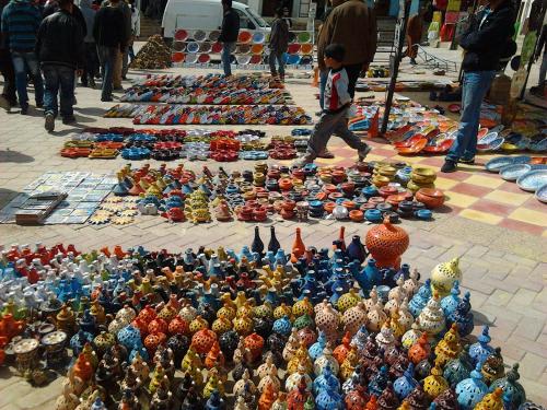 a large pile of figurines on a street at Auberge Alferdaous in Tataouine