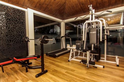 a gym with treadmills and weights in a room at Clove Transit Hotel in Kotugoda
