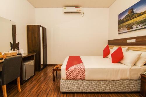 a hotel room with a bed and a desk at Clove Transit Hotel in Kotugoda