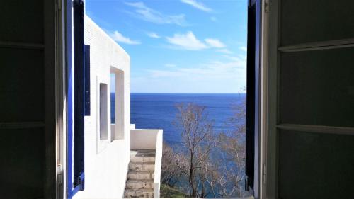 a view of the ocean from an open window at Vitali Beach Houses in Andros