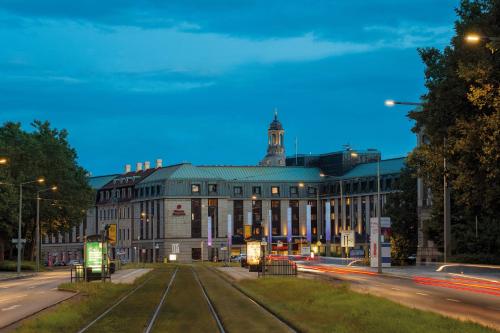 a building with two train tracks in front of it at Bilderberg Bellevue Hotel Dresden in Dresden