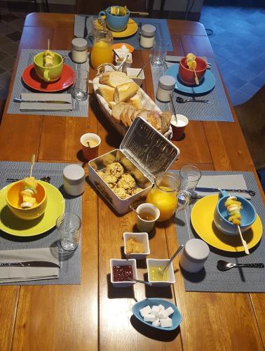 a table with plates of food on top of it at Clos St Ange (Dinan-St Malo) in Vildé-Guingalan