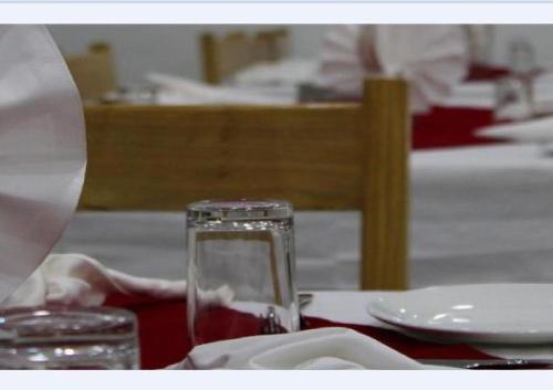 a table with a glass of wine on a table at Himalayan Retreat-Karzoo in Leh