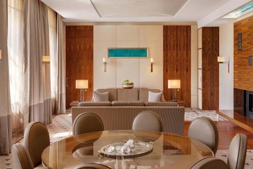 a living room with a table and a couch at Bilderberg Bellevue Hotel Dresden in Dresden