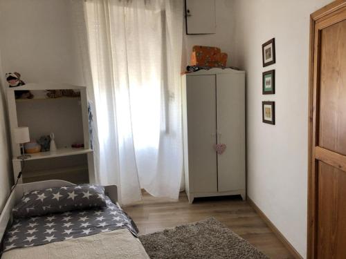 a bedroom with a bed and a white cabinet at Appartamento a Viterbo in Viterbo