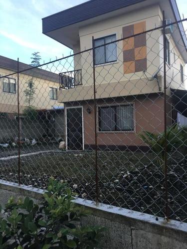 a chain link fence in front of a house at Pines Mansion II in Butuan