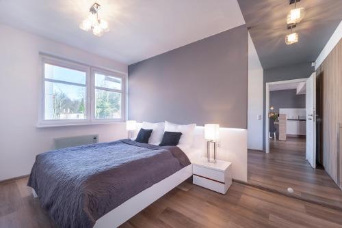 a bedroom with a large bed and a window at Apartments Secret Garden Sopot by Renters in Sopot