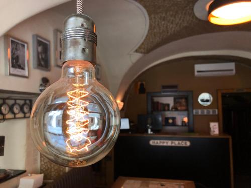 a glass light bulb hanging from a ceiling at U Schnellu in Prague