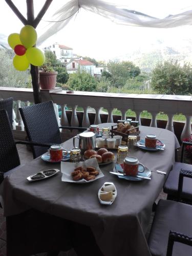 a table with food and drinks and balloons on it at Casa Panoramica Vintage in Tramonti