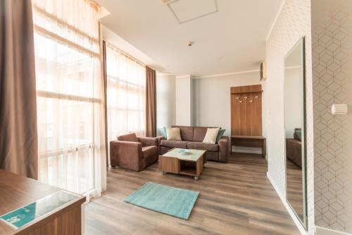 a living room with a couch and a table at Balkan Hotel Garni in Belgrade
