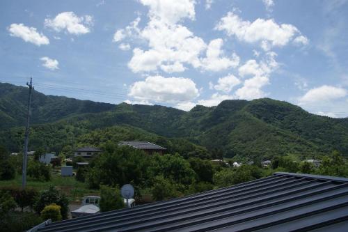 a view of the mountains from a house at Shinshu Wakaho Gibier B&B in Nagano