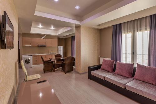 a living room with a couch and a table at Diplomat Suites in Baku